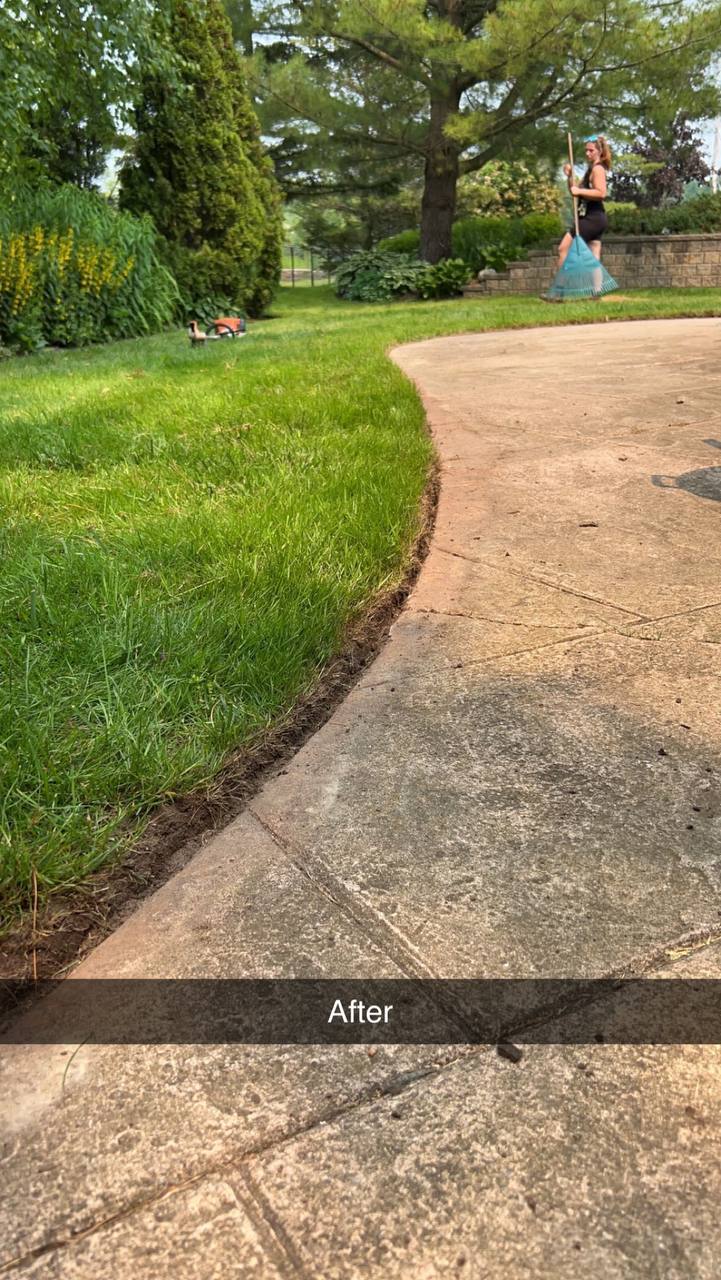 Fresh lawn edge and walkway after property maintenance